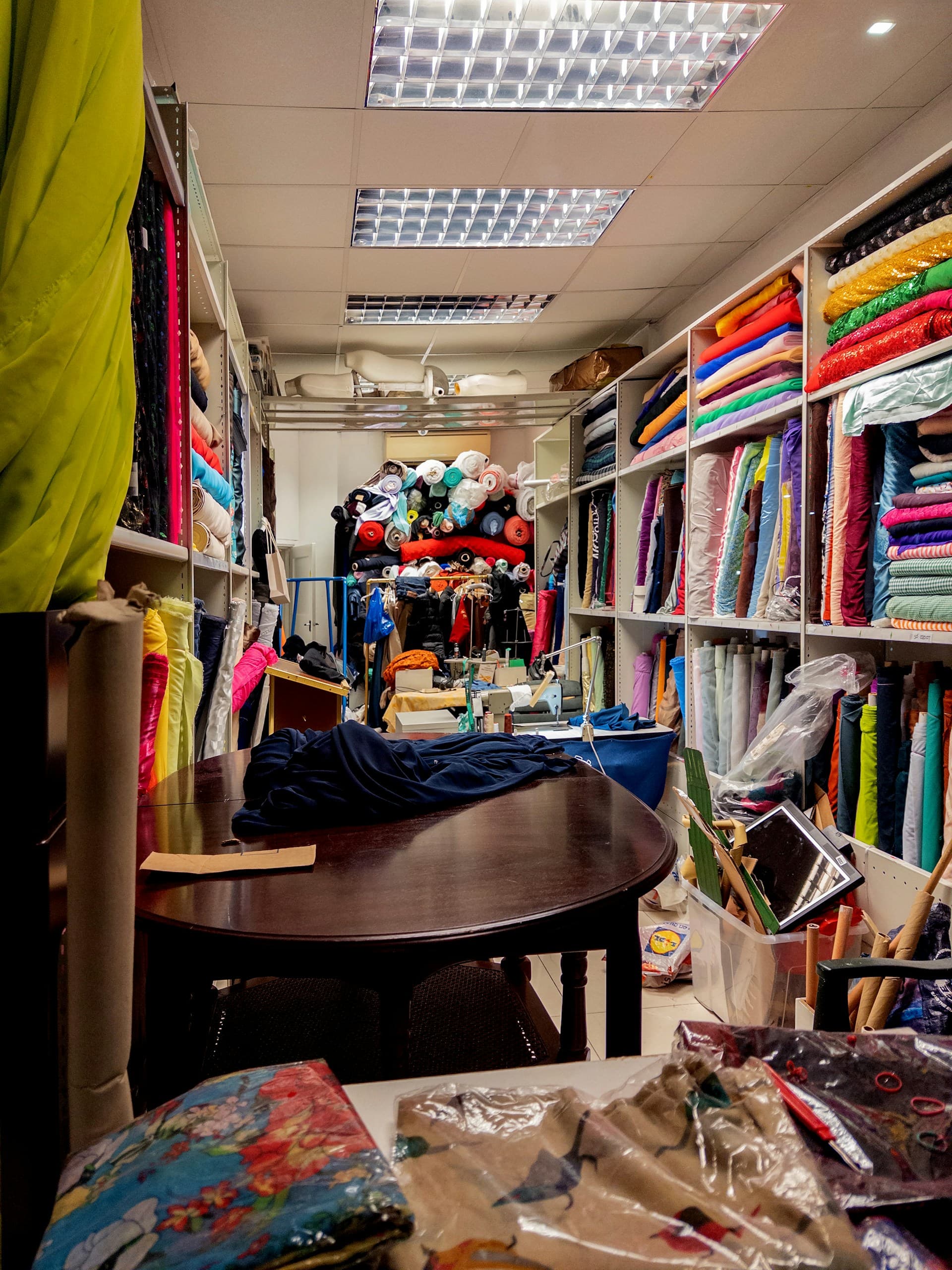 Fabric store shelves filled with colorful textile rolls