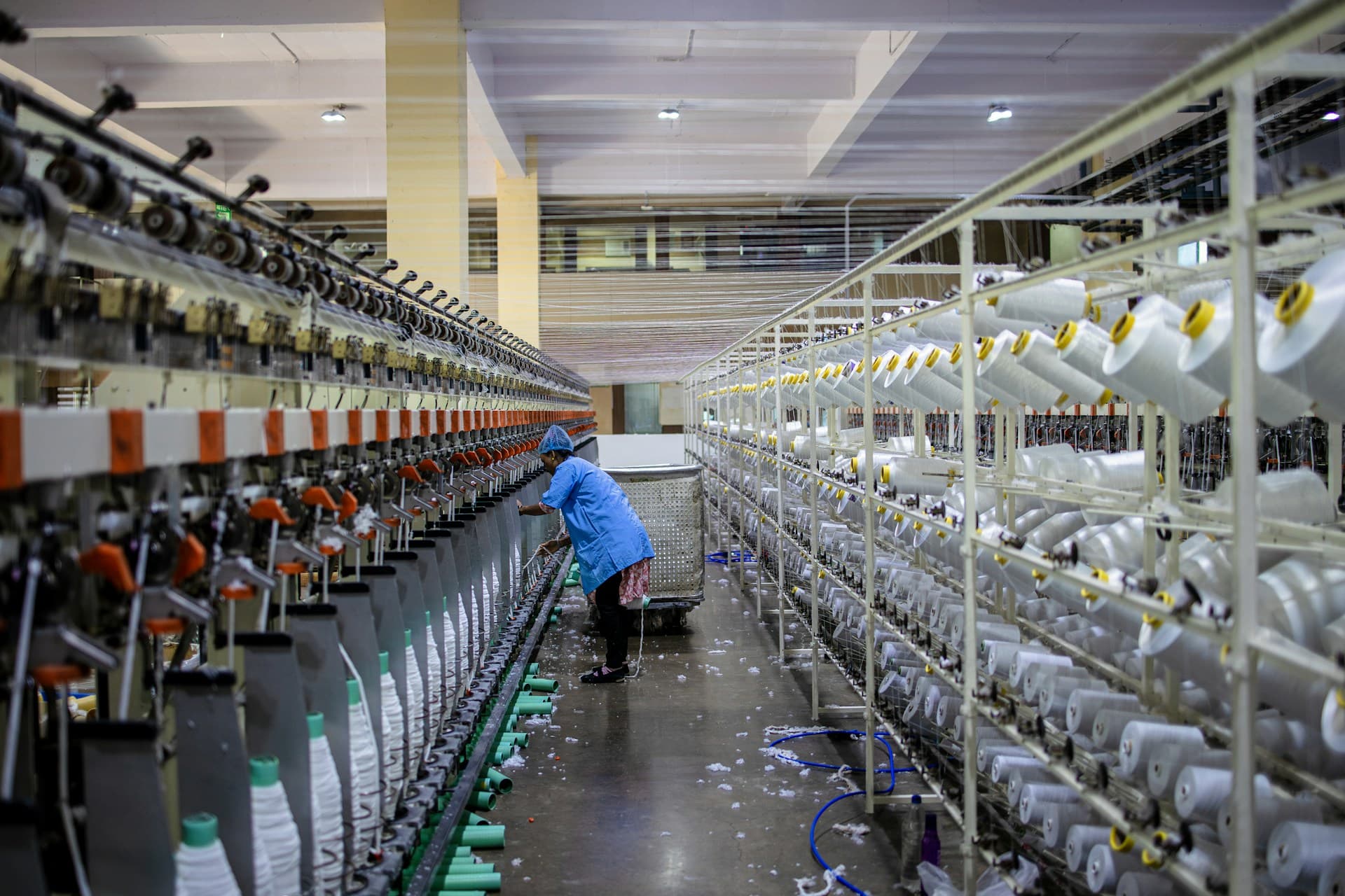 Workers in a textile factory inspecting production